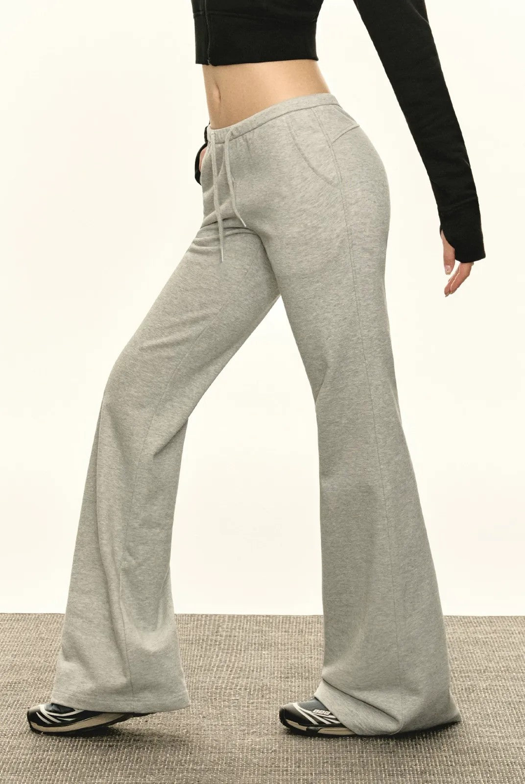 ARISEISM Low Rise Micro Flare Sweatpants in Gray - On Model