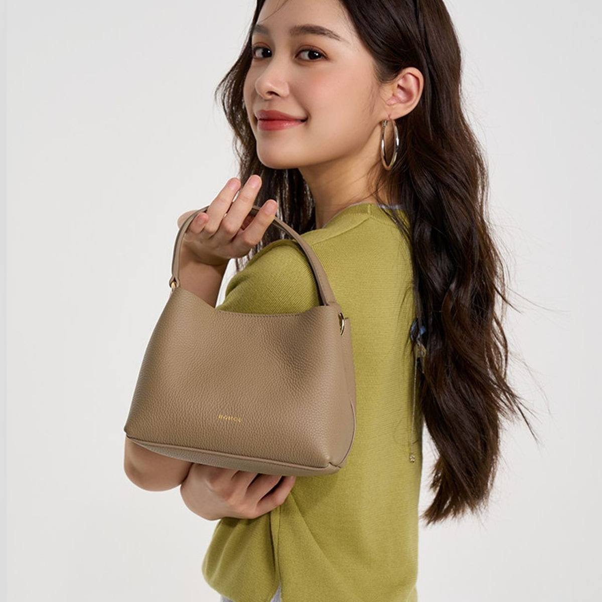 HONGU Textured Leather Top Handle Bucket Bag in Taupe - On Female Model