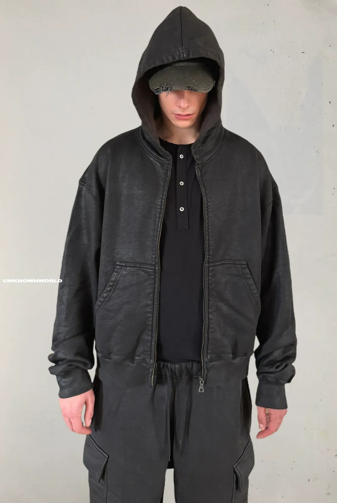 UNKNOWNWORLD Hand Waxed Cotton Zip Up Hoodie in Black - On Model