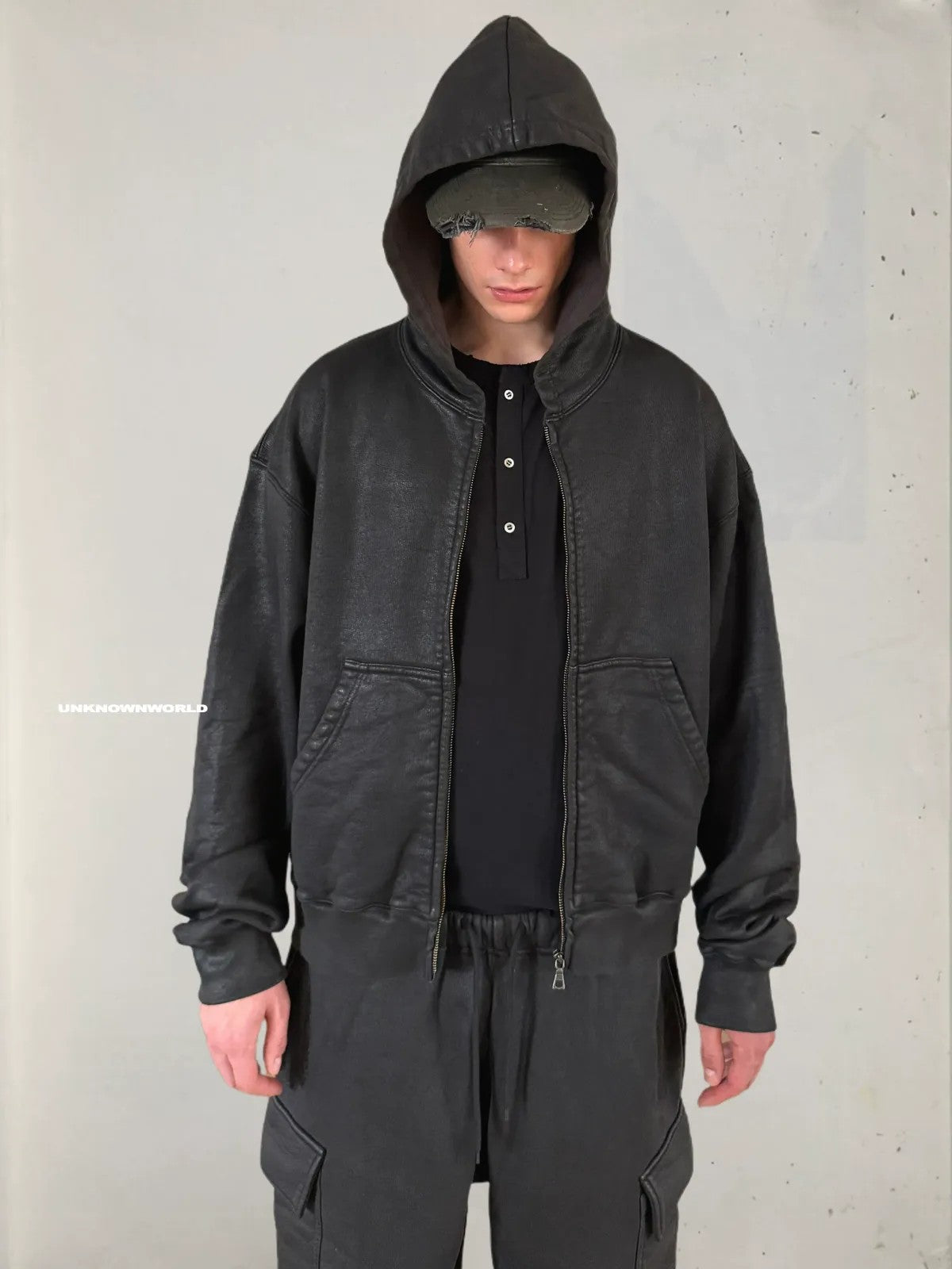 UNKNOWNWORLD Hand Waxed Cotton Zip Up Hoodie in Black - On Model