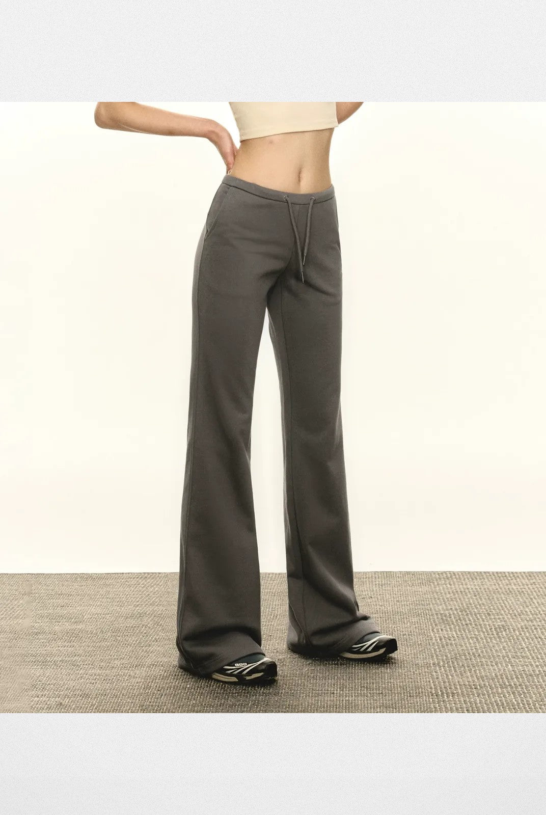 ARISEISM Low Rise Micro Flare Sweatpants in Gray - On Model