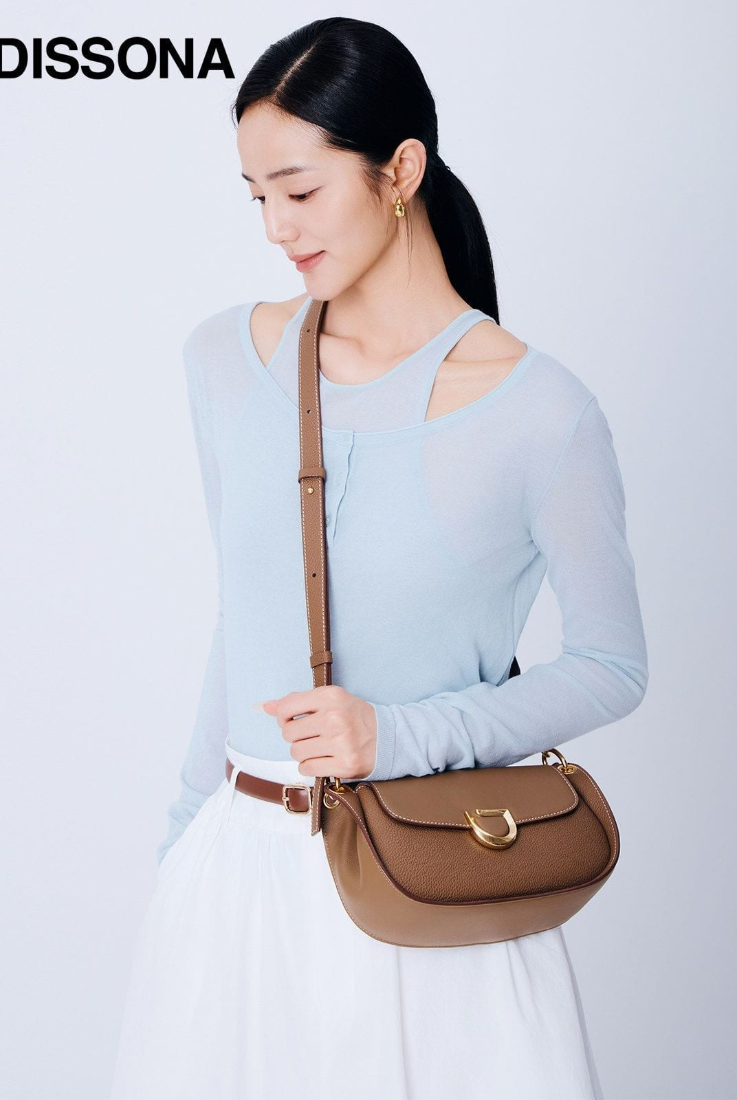 DISSONA Leather Crossbody Saddle Bag in Beige - On Female Model