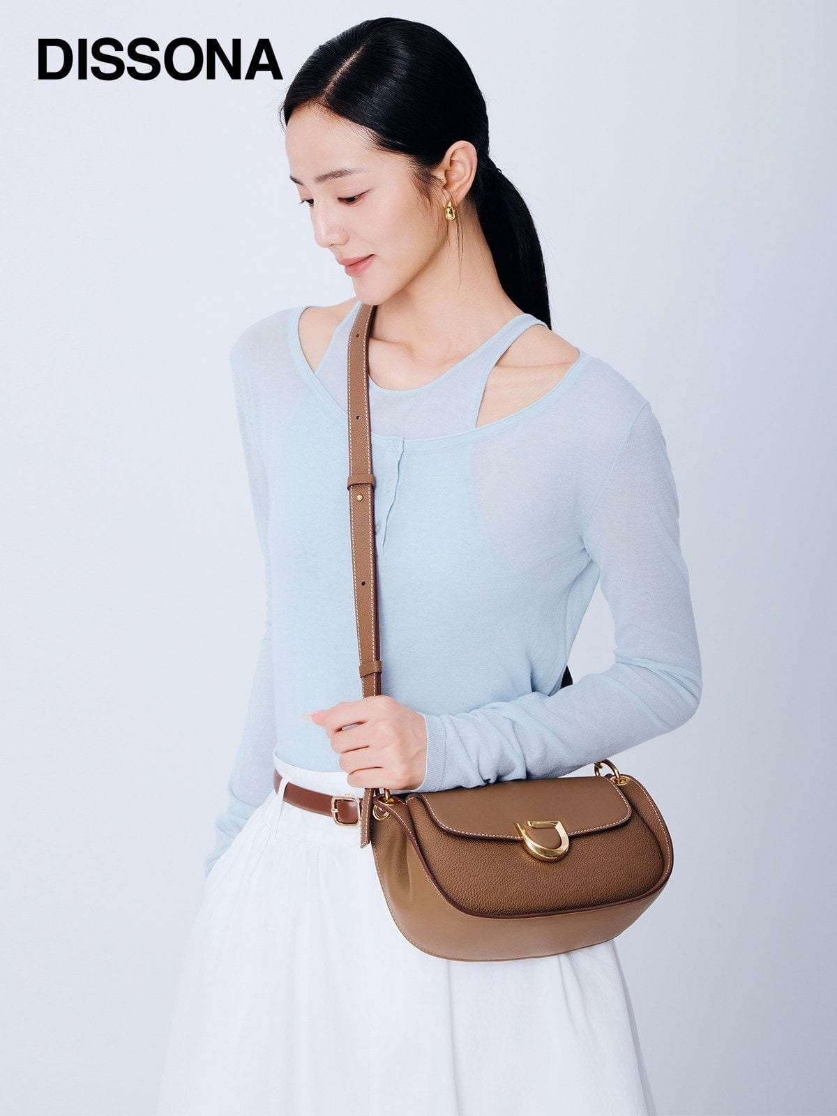 DISSONA Leather Crossbody Saddle Bag in Beige - On Female Model