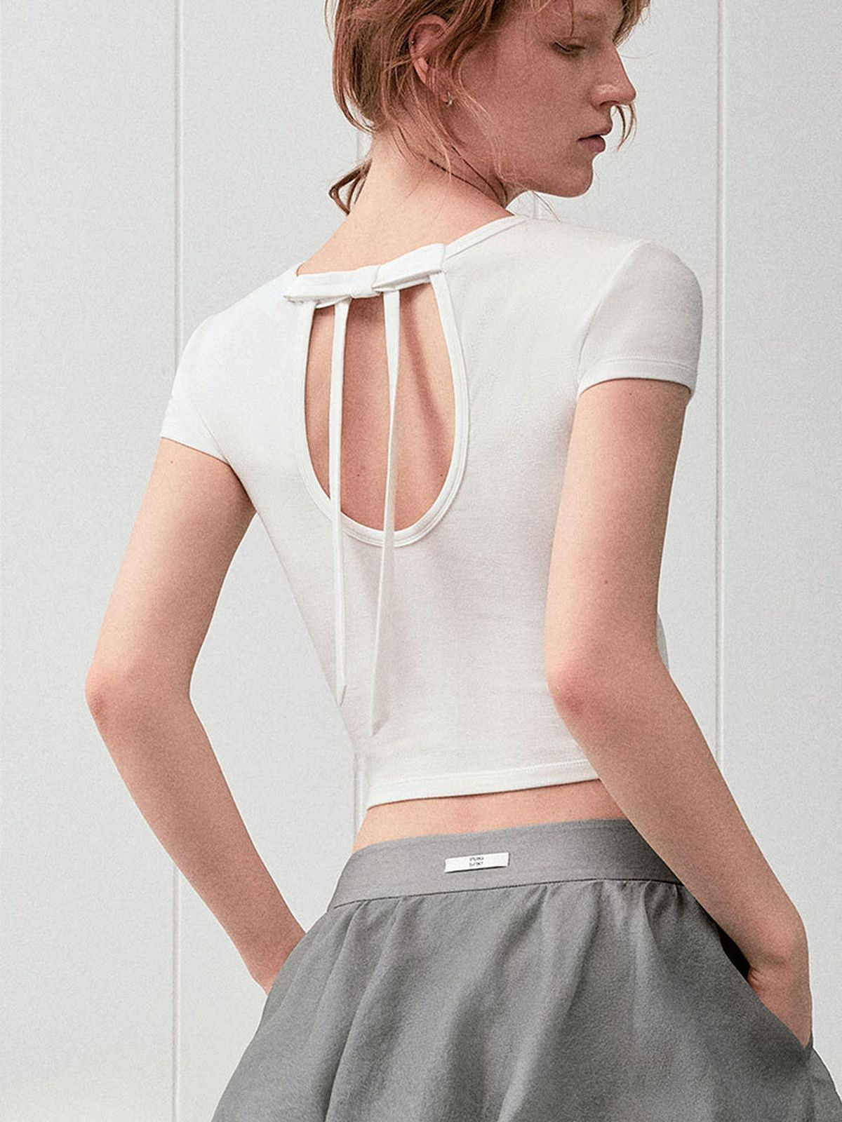 PUKI Open Back Bow Detail T Shirt in White - On Model