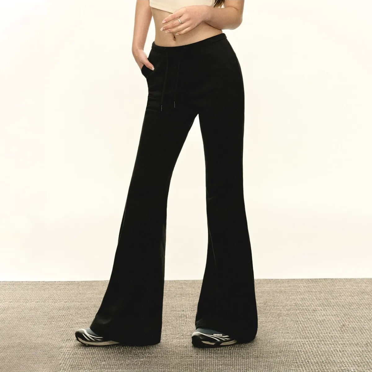 ARISEISM Low Rise Micro Flare Sweatpants in Black - On Model
