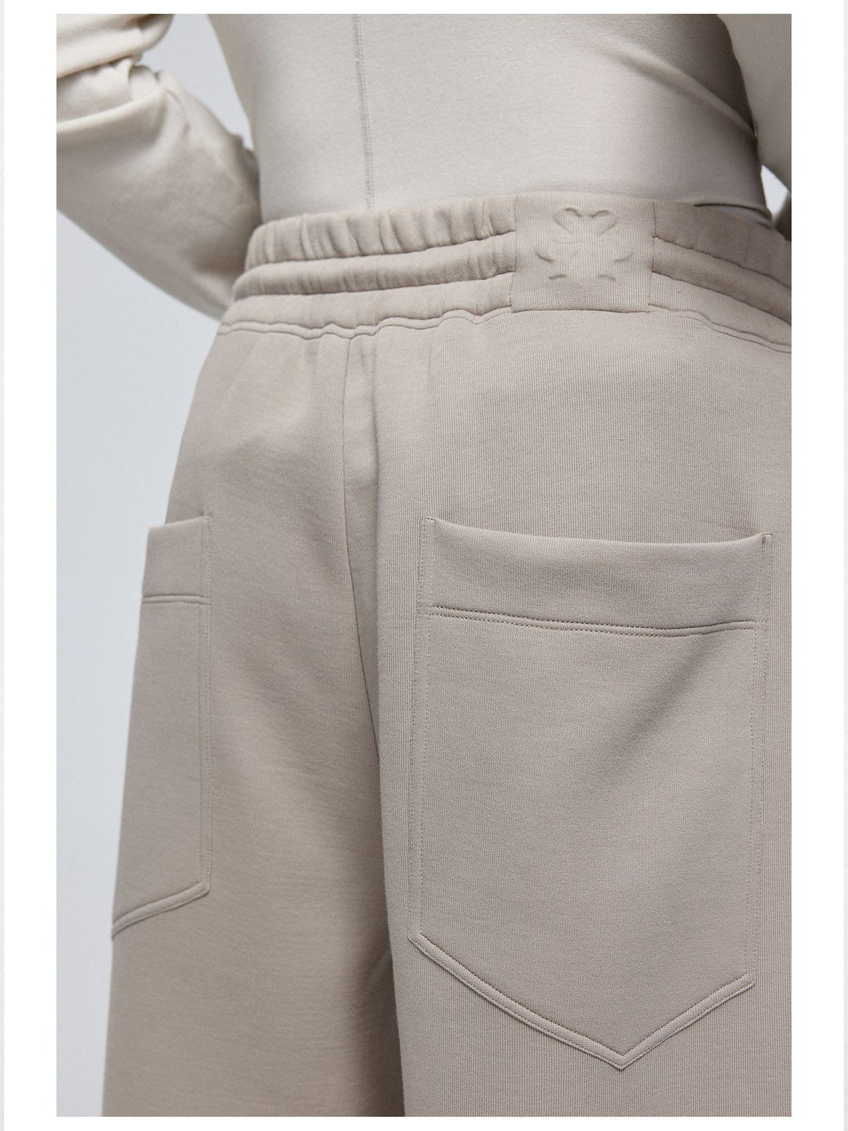 Simple Project Logo Embossed Wide Leg Sweatpants in Beige - Detail