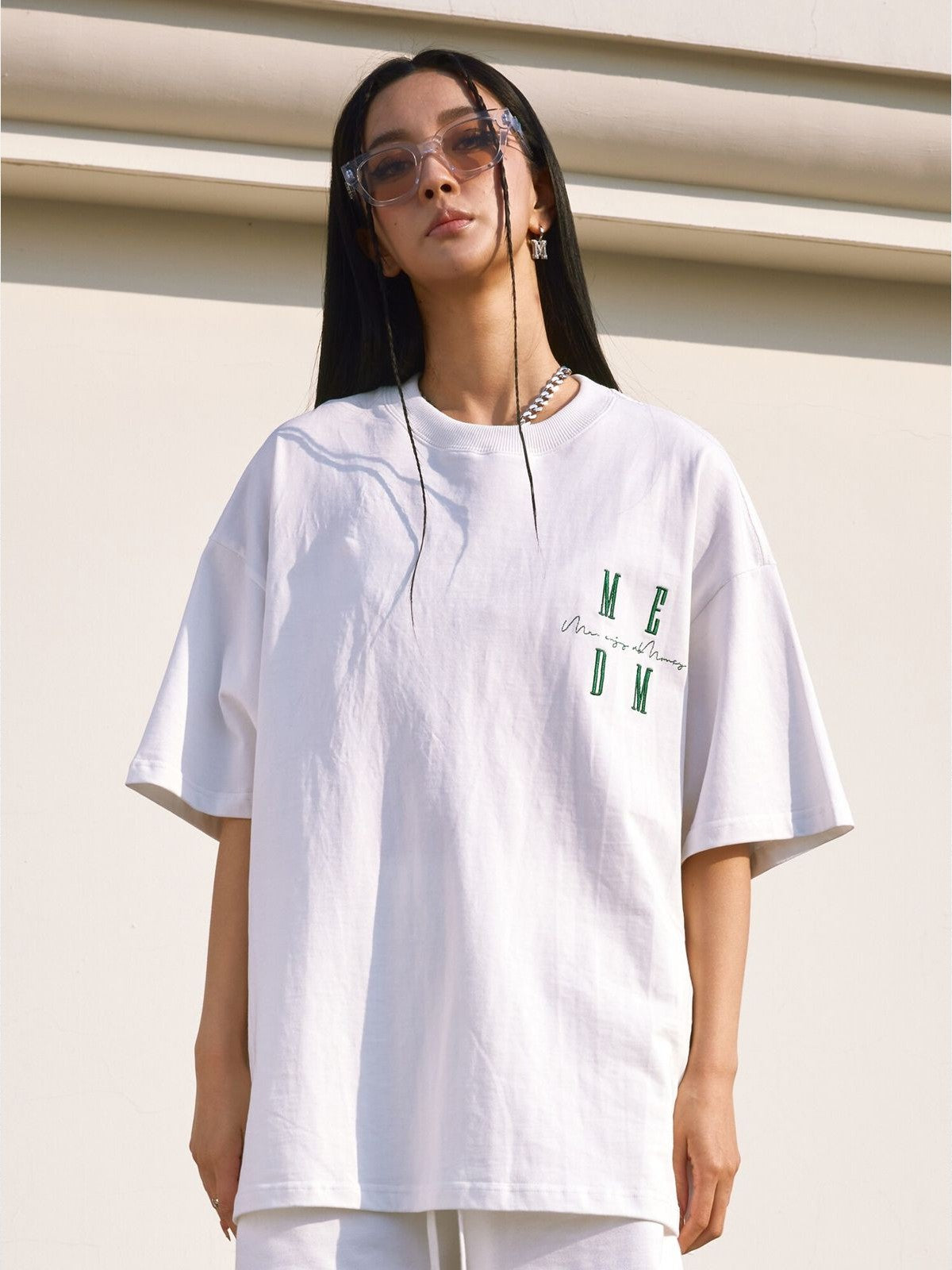 MEDM Oversized Logo Print T Shirt in White - On Female Model