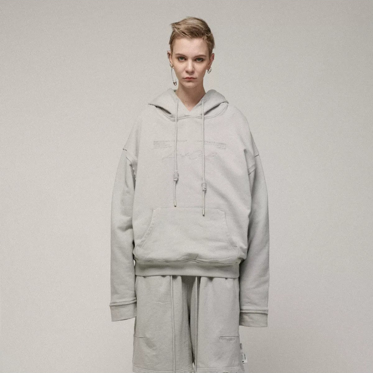 LOSTCTRL Embroidered Raw Edge Cotton Hoodie in Gray - On Model