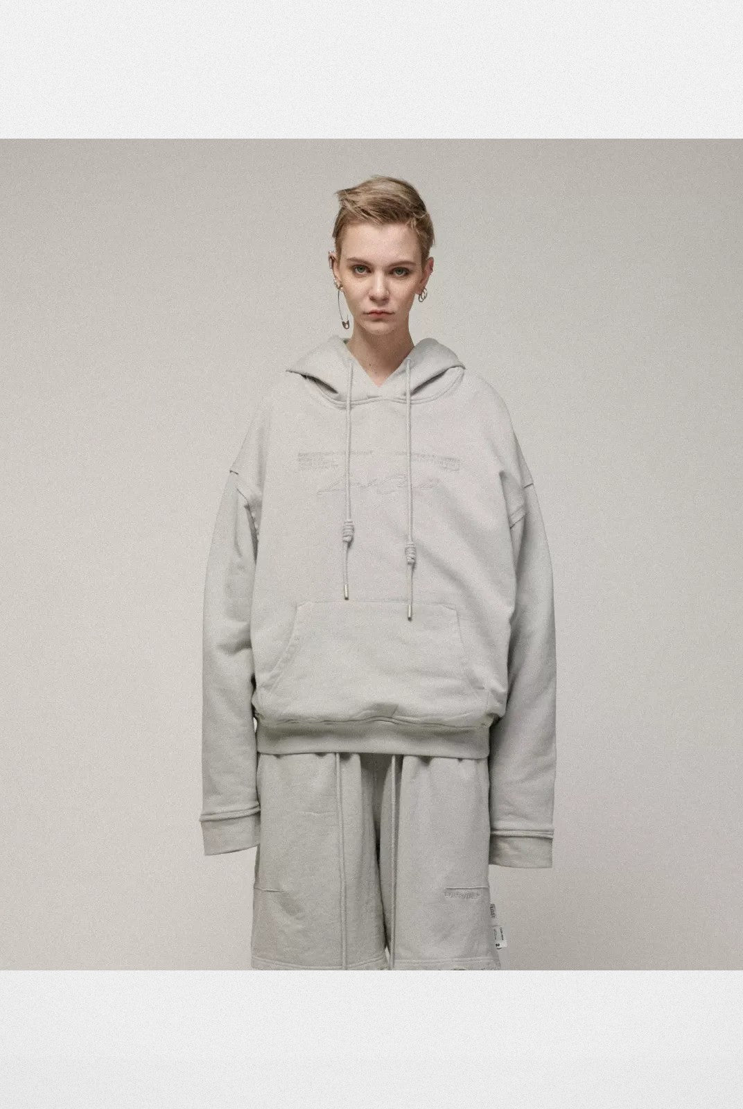 LOSTCTRL Embroidered Raw Edge Cotton Hoodie in Gray - On Model