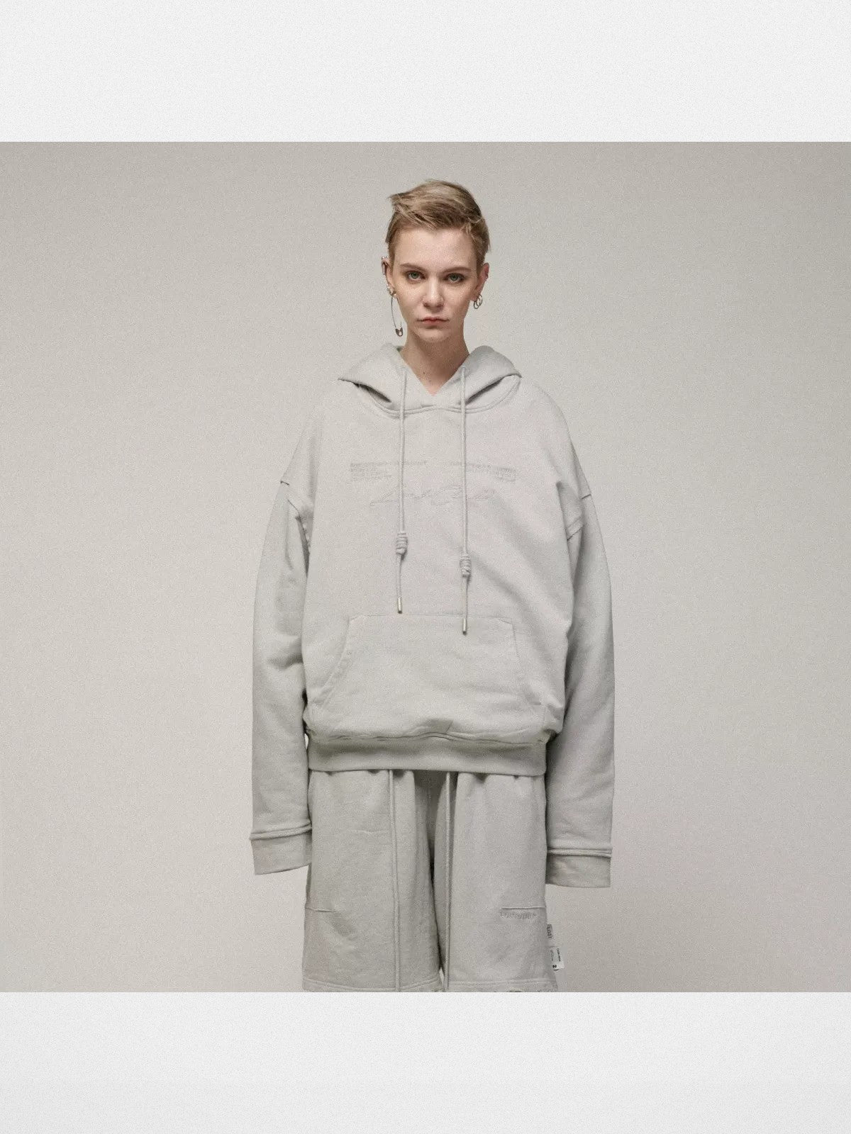 LOSTCTRL Embroidered Raw Edge Cotton Hoodie in Gray - On Model