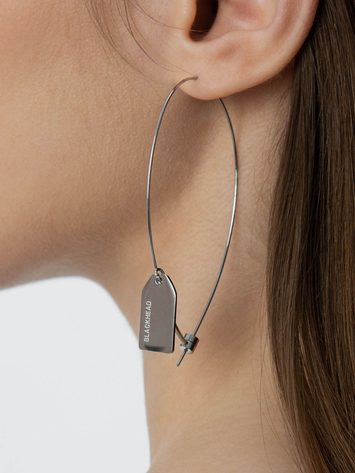 BLACKHEAD Steel Label Tag Wire Earrings in Gray - On Model