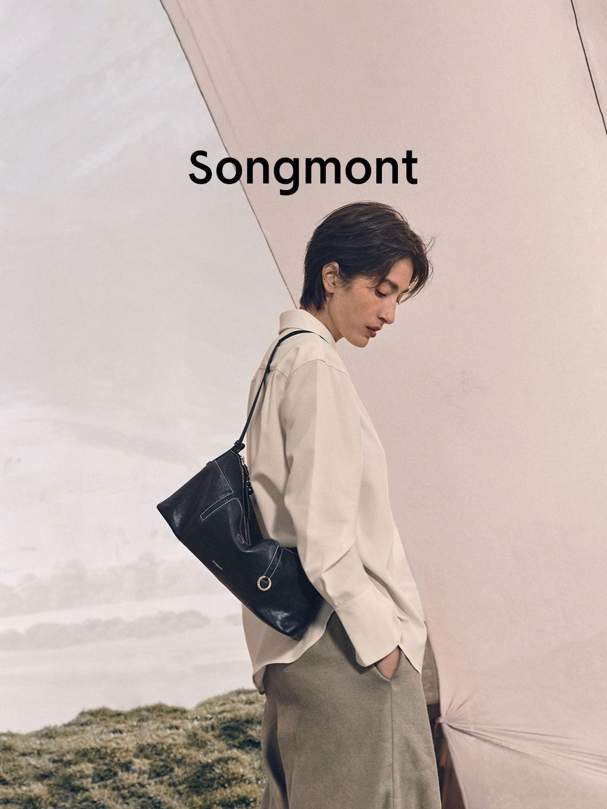 Songmont Vegetable Tanned Lambskin Pillow Hobo in Black - On Male Model