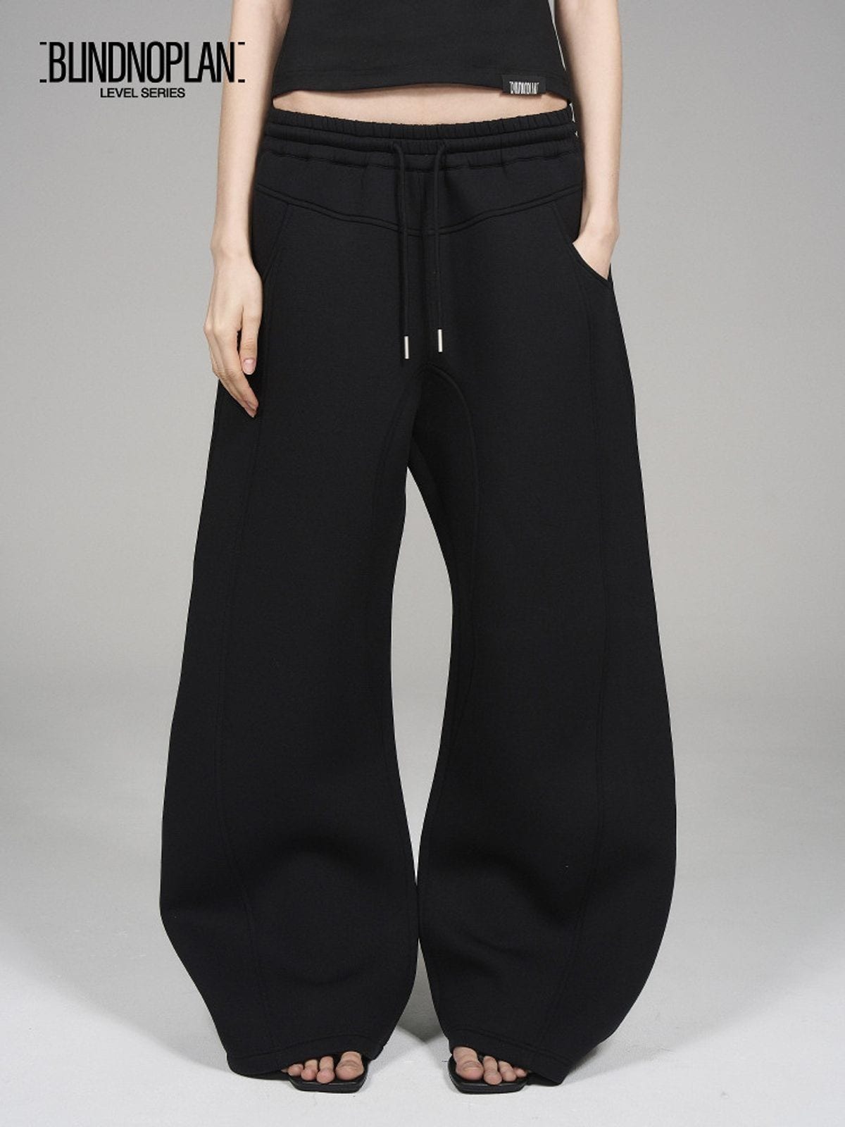 Blindnoplan Heavyweight Curved Leg Sweatpants in Black - On Model