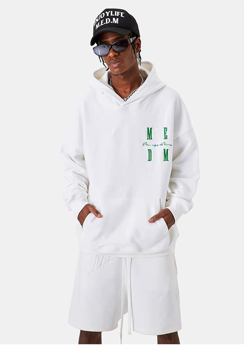 MEDM Embroidered Logo Hoodie in White - On Male Model