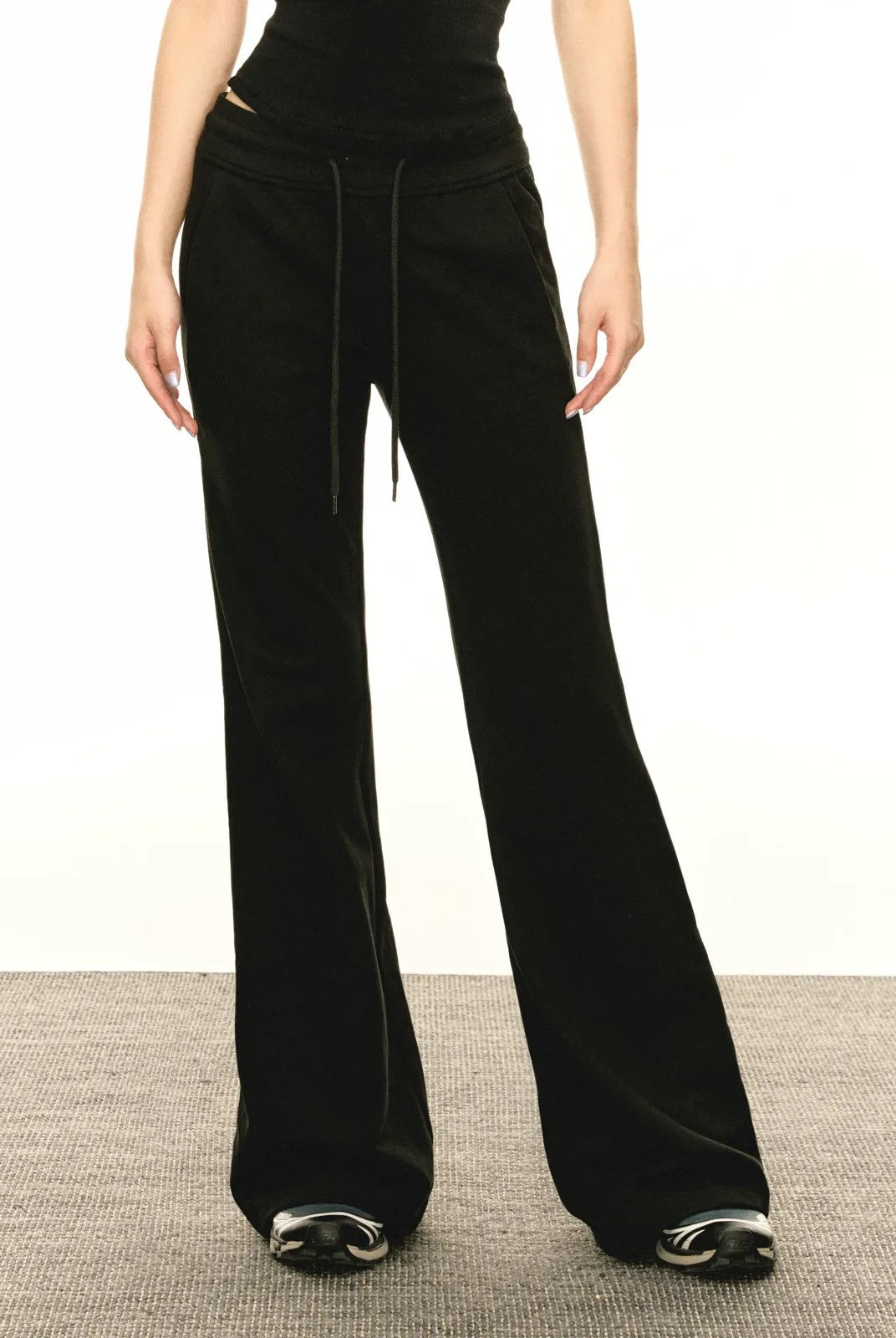 Ariseism Low Rise Micro Flare Sweatpants in Black - On Model