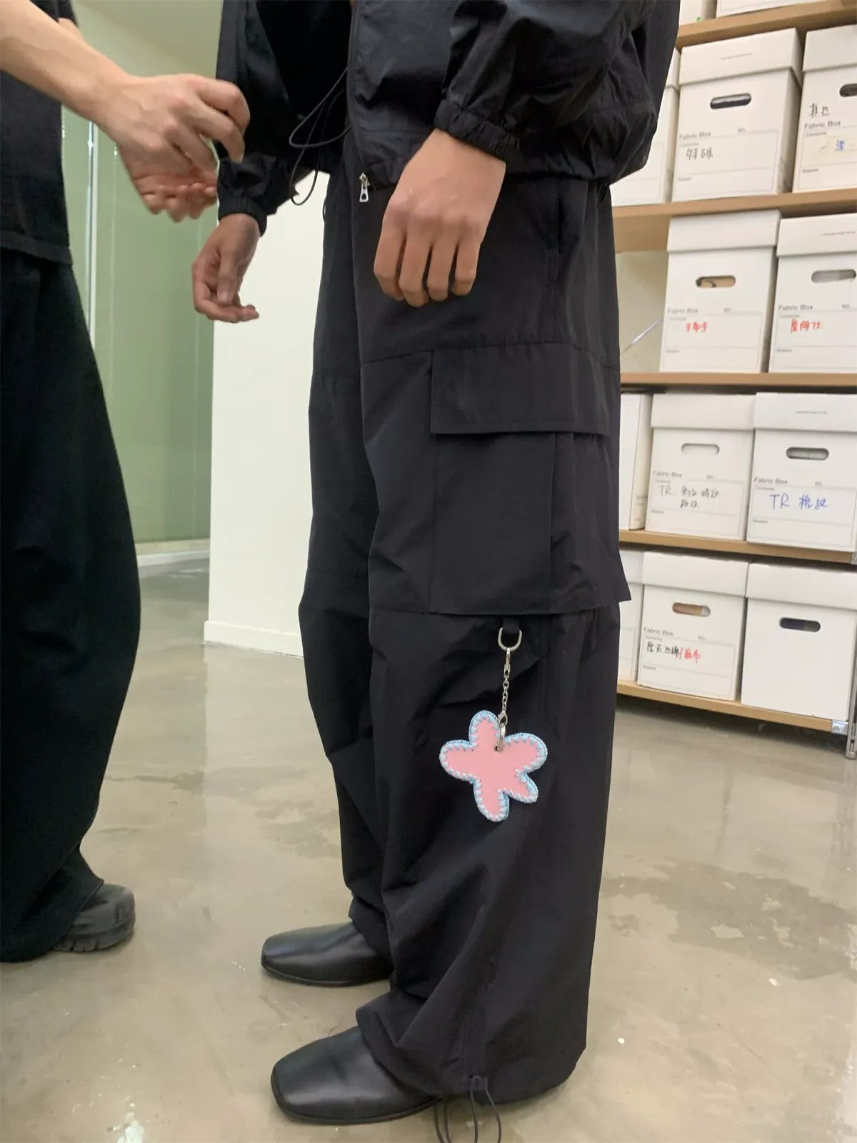 NeverSeez Accordion Pocket Wide Leg Cargo Pants in Black - On Male Model