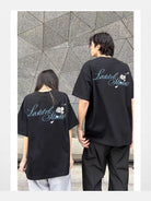 LOSTCTRL Camellia Graphic Print T Shirt in Black - On Mixed Models