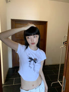 NeverSeez Lace Bow Graphic Baby Tee in White - On Model