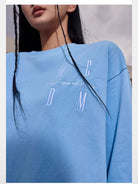 MEDM Embroidered Logo Long Sleeve Tee in Sky Blue - On Female Model