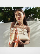 WANLIMA Cowhide Leather Top Handle Bag in White - On Female Model