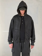 UNKNOWNWORLD Hand Waxed Cotton Zip Up Hoodie in Black - On Model