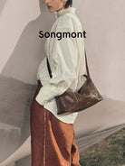 Songmont Vegetable Tanned Lambskin Pillow Hobo in Brown - On Male Model