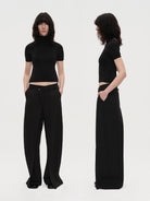 RARELY ALIKE Open Back Wool Mock Neck Top in Black - On Model