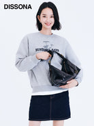 DISSONA Distressed Leather Crescent Hobo Bag in Black - On Female Model