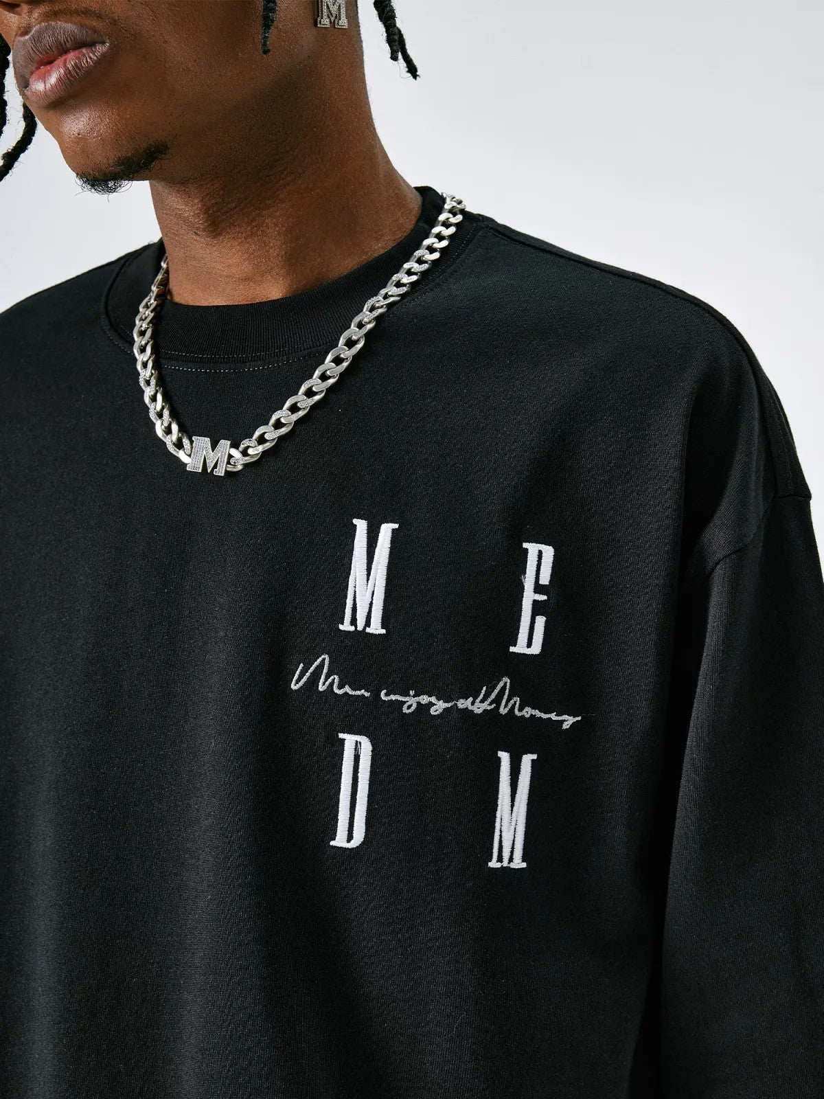 MEDM Embroidered Logo Long Sleeve Tee in Black - On Male Model