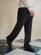 Roolrren Homme Textured Wool Drawstring Trousers in Black - On Model