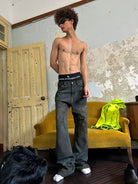 TRIANGLE PROJECT Mud Dyed Hand Painted Distressed Jeans in Dark Gray - On Model