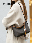 FION Monogram Coated Canvas Hobo Bag in Brown - On Female Model