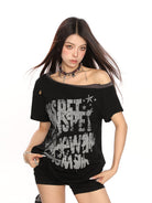 BIGGOLD STUDIO Distressed Graffiti Off Shoulder Tee in Black - On Model #color_black