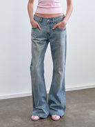 RARELY ALIKE Mid Rise Asymmetric Hem Flared Jeans in Sky Blue - On Model