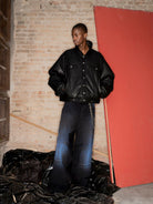 TRIANGLE PROJECT Dirty Wash Spray Detail Jeans in Black - On Model