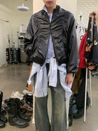 NeverSeez Glossy Ruched Tencel Windbreaker in Black - On Male Model