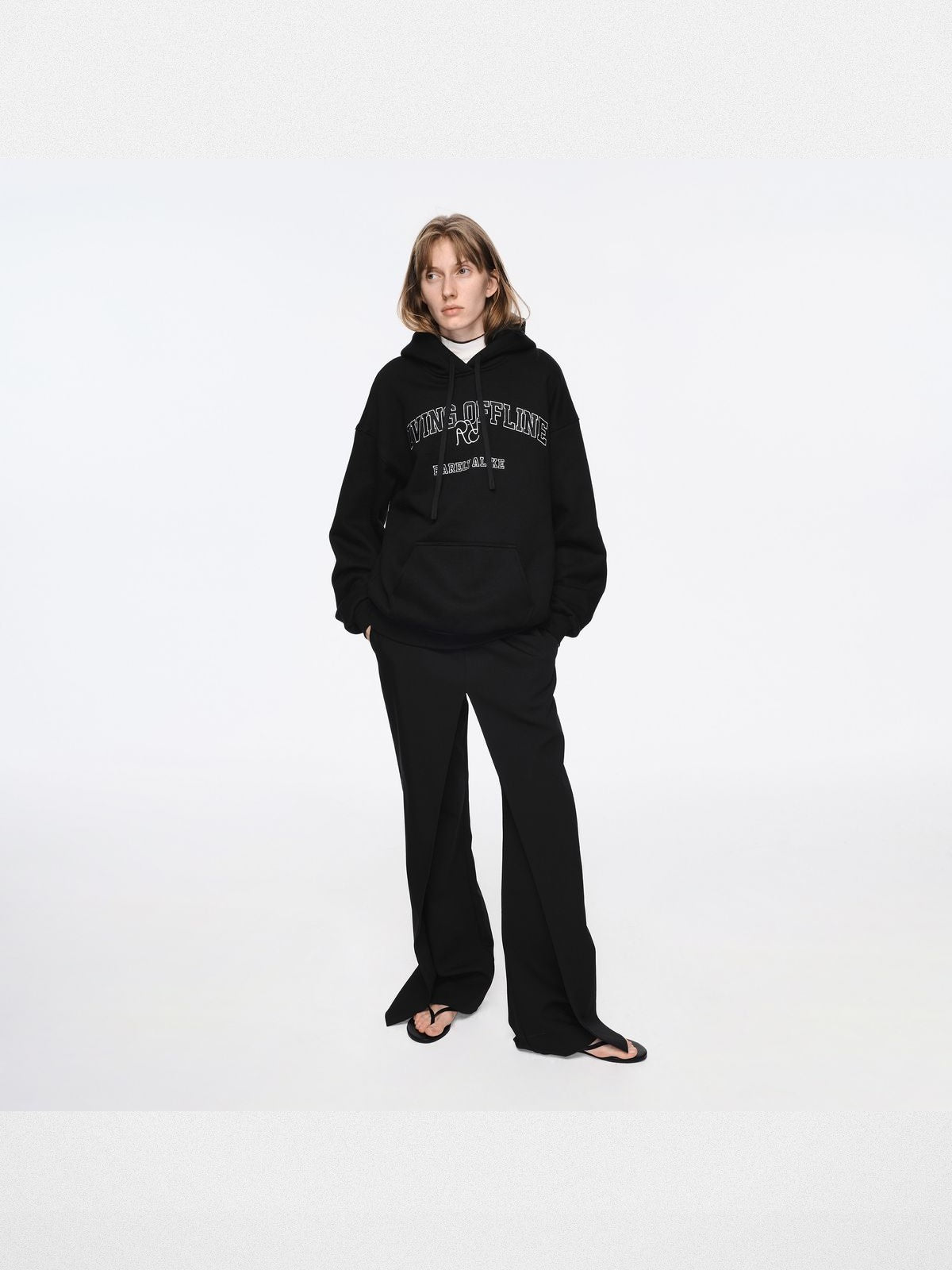 RARELY ALIKE Living Offline Embroidered Fleece Hoodie in Black - On Model