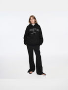 RARELY ALIKE Living Offline Embroidered Fleece Hoodie in Black - On Model