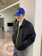 NeverSeez Leather Down Puffer Jacket in Black - On Male Model