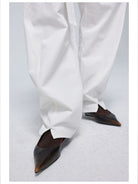 Simple Project Twisted Belt Curved Leg Pants in White - On Female Model