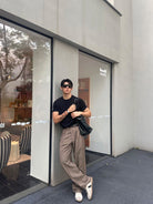 Roolrren Homme Pleated Wool Trousers in Beige - On Model