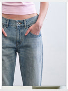 RARELY ALIKE Mid Rise Asymmetric Hem Flared Jeans in Sky Blue - On Model