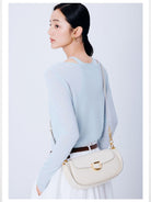 DISSONA Leather Crossbody Saddle Bag in Cream - On Female Model