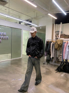 NeverSeez Glossy Ruched Tencel Windbreaker in Black - On Male Model