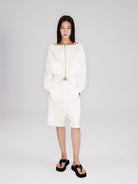 RARELY ALIKE Seamed Cotton Sweat Shorts in White - On Model