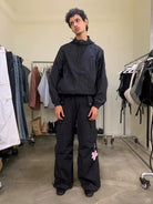 NeverSeez Accordion Pocket Wide Leg Cargo Pants in Black - On Male Model