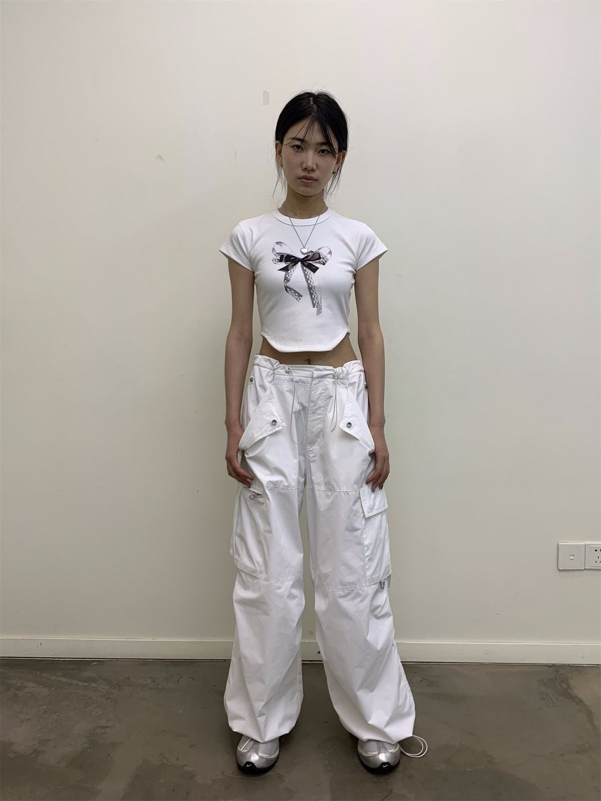 NeverSeez Lace Bow Graphic Baby Tee in White - On Model