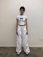 NeverSeez Lace Bow Graphic Baby Tee in White - On Model