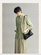 Songmont Vegetable Tanned Lambskin Pillow Hobo in Black - On Male Model