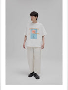 NANS Wilderness Parade Mercerized Tee in Orange - On Model